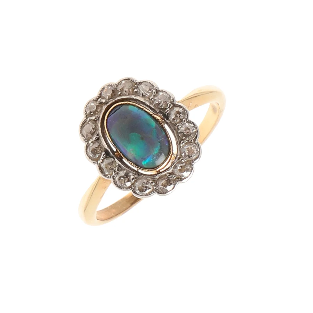 AN EARLY 20TH CENTURY OPAL AND DIAMOND CLUSTER RING. — Rings — Lawrences Auctioneers