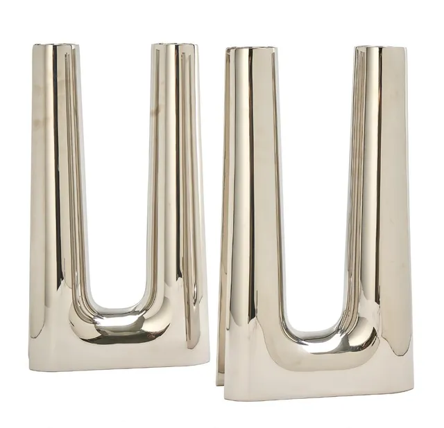 A pair of large stainless steel candelabra with two candle holders. Made and marked for Georg Jensen, Denmark. H. 43.8 cm. W. max. 24.5 cm. Inner diam. of candle holders 6 cm. (2)
