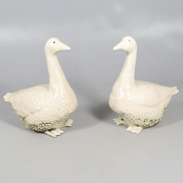 A LARGE PAIR OF CERAMIC GEESE.