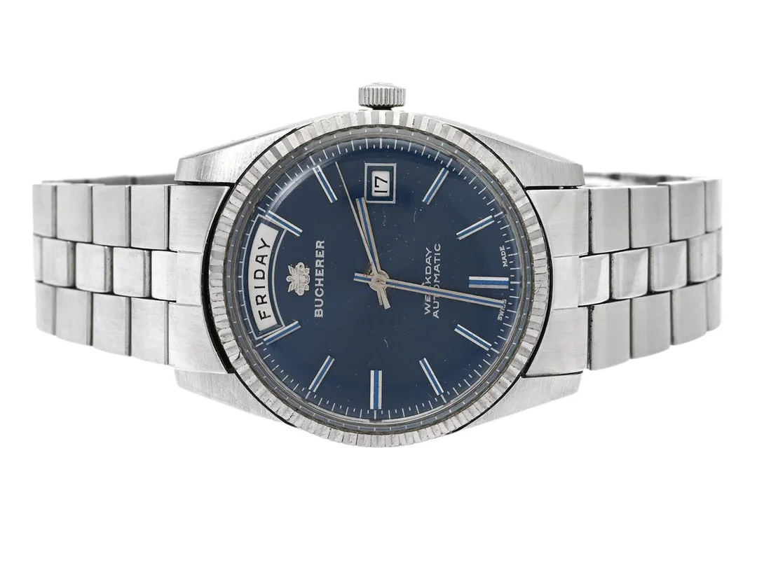 BUCHERER, Weekday (Swiss Made), Cal AS 1985, Boett nr. 30 139, herrur, 37 mm, stål, automatisk, plexiglas, dag, datum, skadad urtavla, originallänk, viklås, ca 1975. — Klockor/Bucherer — Kaplans