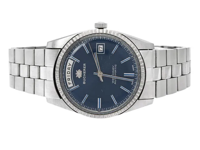 BUCHERER, Weekday (Swiss Made), Cal AS 1985, Boett nr. 30 139, herrur, 37 mm, stål, automatisk, plexiglas, dag, datum, skadad urtavla, originallänk, viklås, ca 1975.