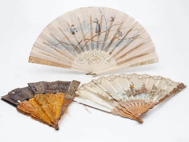 Three fans with leavesin paper and tulle, early 20th Century.
