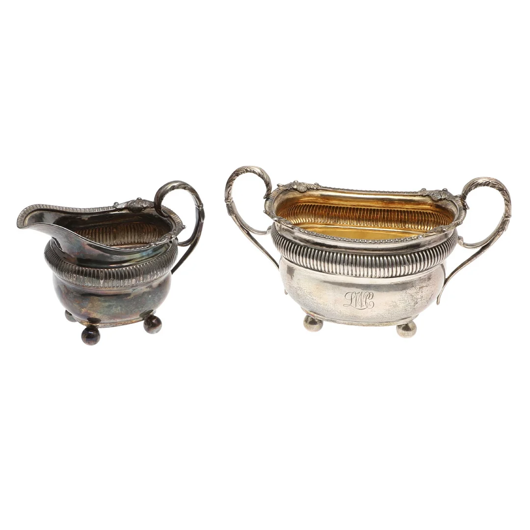 A GEORGE III SILVER TWIN HANDLED SUGAR BASIN AND MATCHING MILK JUG. — Silver — Lawrences Auctioneers