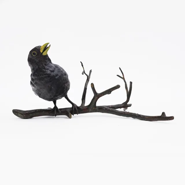 FRANZ BERGMAN (1861-1936). COLD-PAINTED BRONZE BLACKBIRD ON BRANCH.