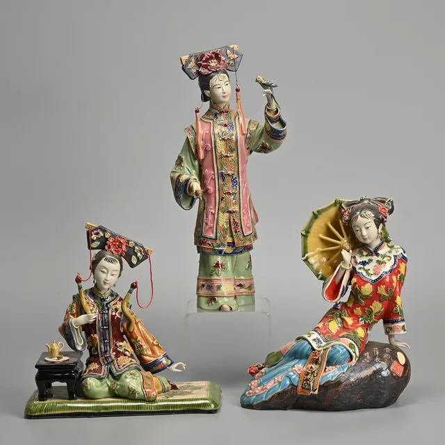 THREE CHINESE POTTERY FIGURES OF WOMEN WITH VARIOUS ATTRIBUTES, 20TH CENTURY, VARIOUS INCISED CHARACTER MARKS AND SEALS.