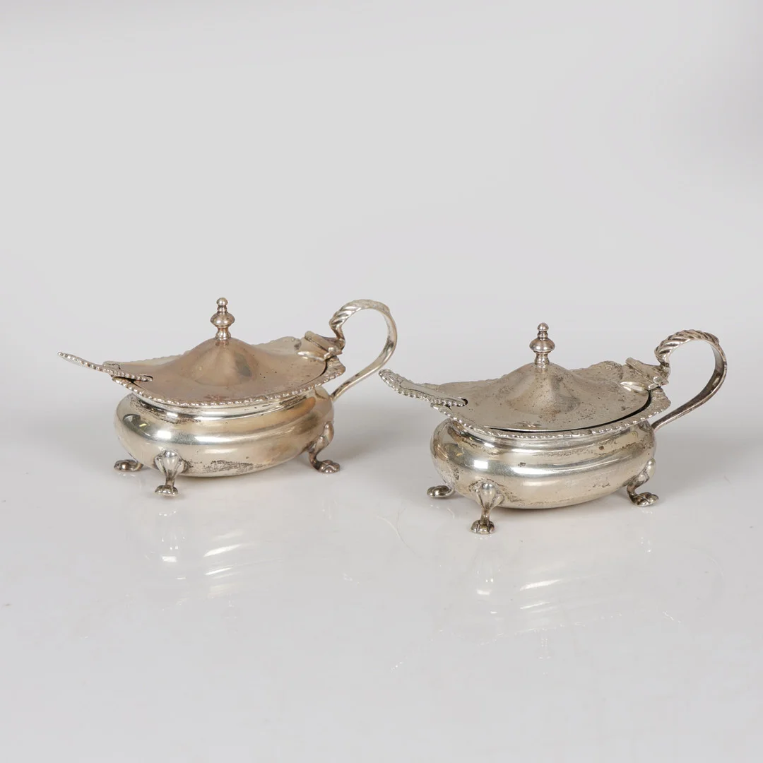 A PAIR OF SILVER MUSTARD POTS AND SPOONS (4). — Silver — Bishop & Miller