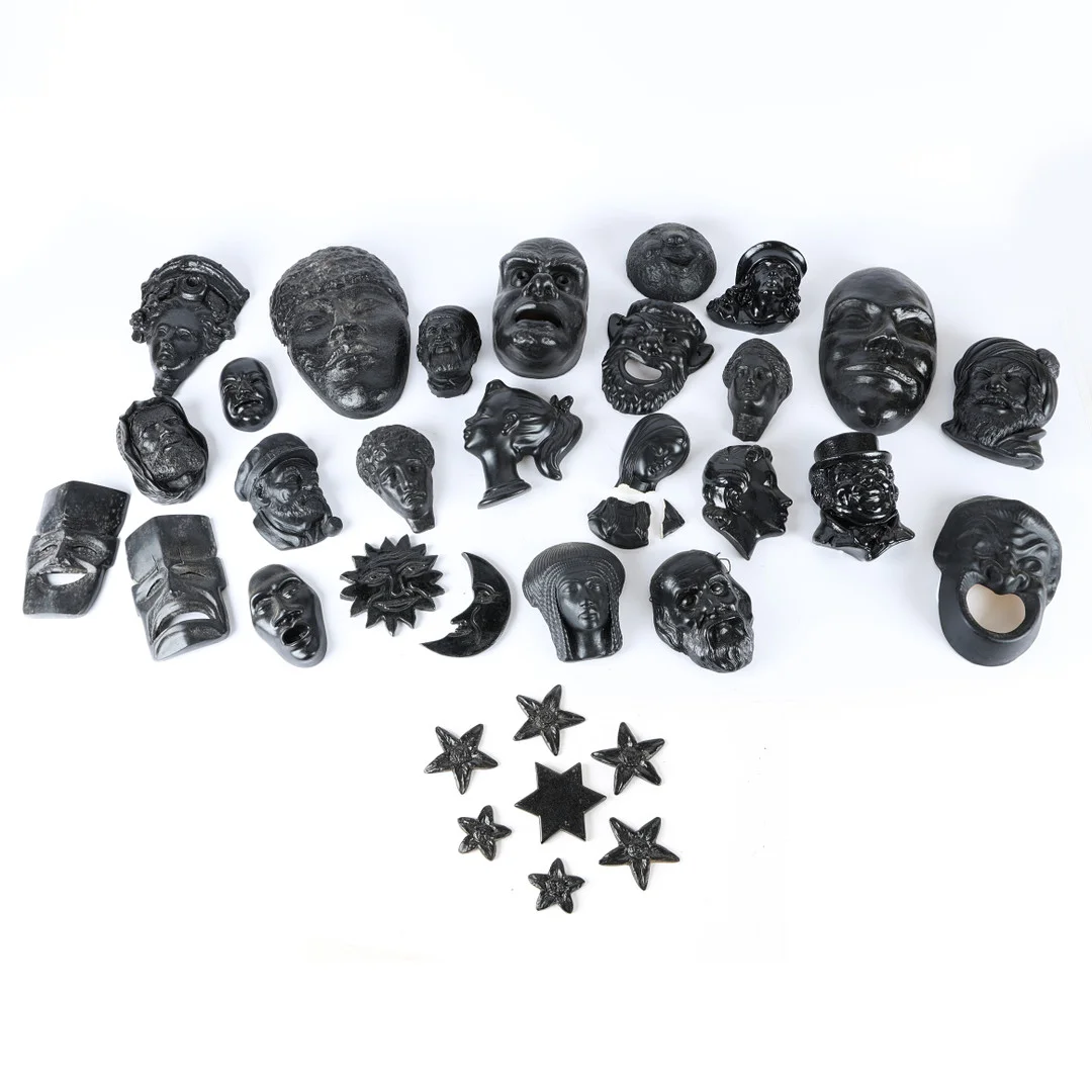 A LARGE COLLECTION OF POTTERY FACES. — European — Bishop & Miller