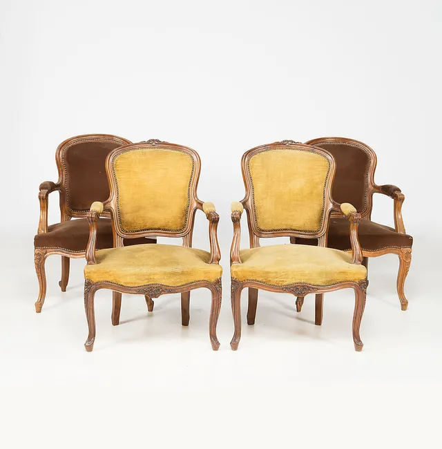 Two pairs of Louis XV-style armchairs in carved walnut, first half of the 20th Century.
