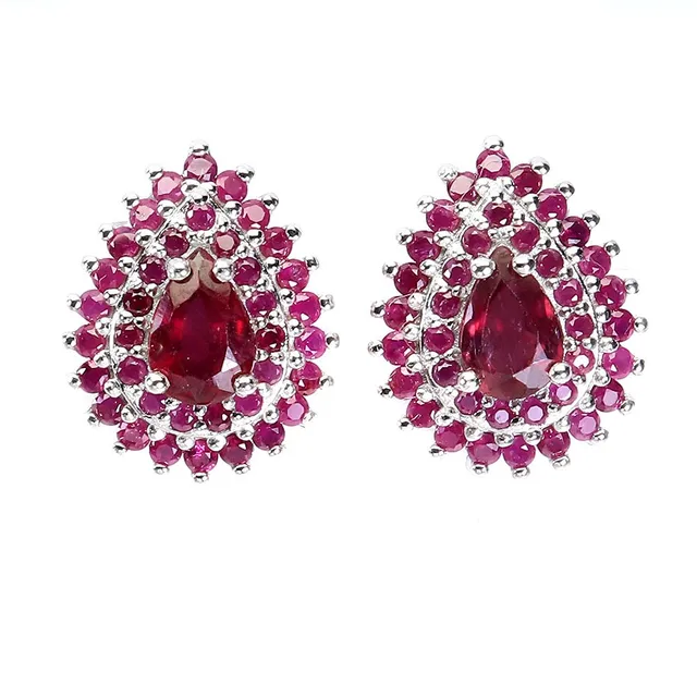 Earrings in rhodium-plated sterling silver adorned with two rubies, surrounded by numerous rubies