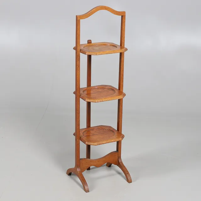 AN OAK FOLDING CAKE STAND.