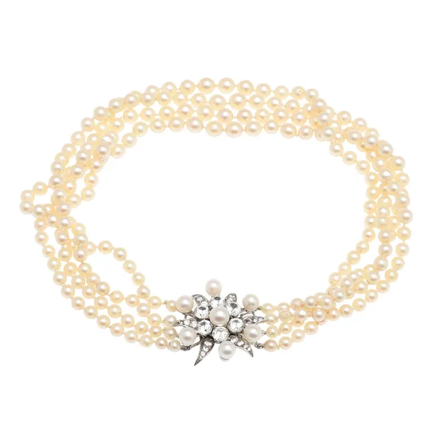 A FOUR STRAND CULTURED PEARL CHOKER WITH PASTE SET CLASP.