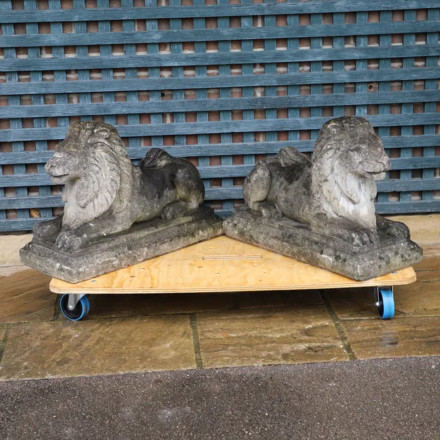 A PAIR OF GARDEN RECUMBENT LIONS.