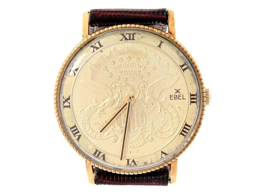 EBEL, Coin Watch, herrur, 33 mm, Cal 97B, Boett nr. 897043 /201, 18K guld, manuell, plexiglas, skadad urtavla, läderband, ca 1975. — Klockor/Ebel — Kaplans