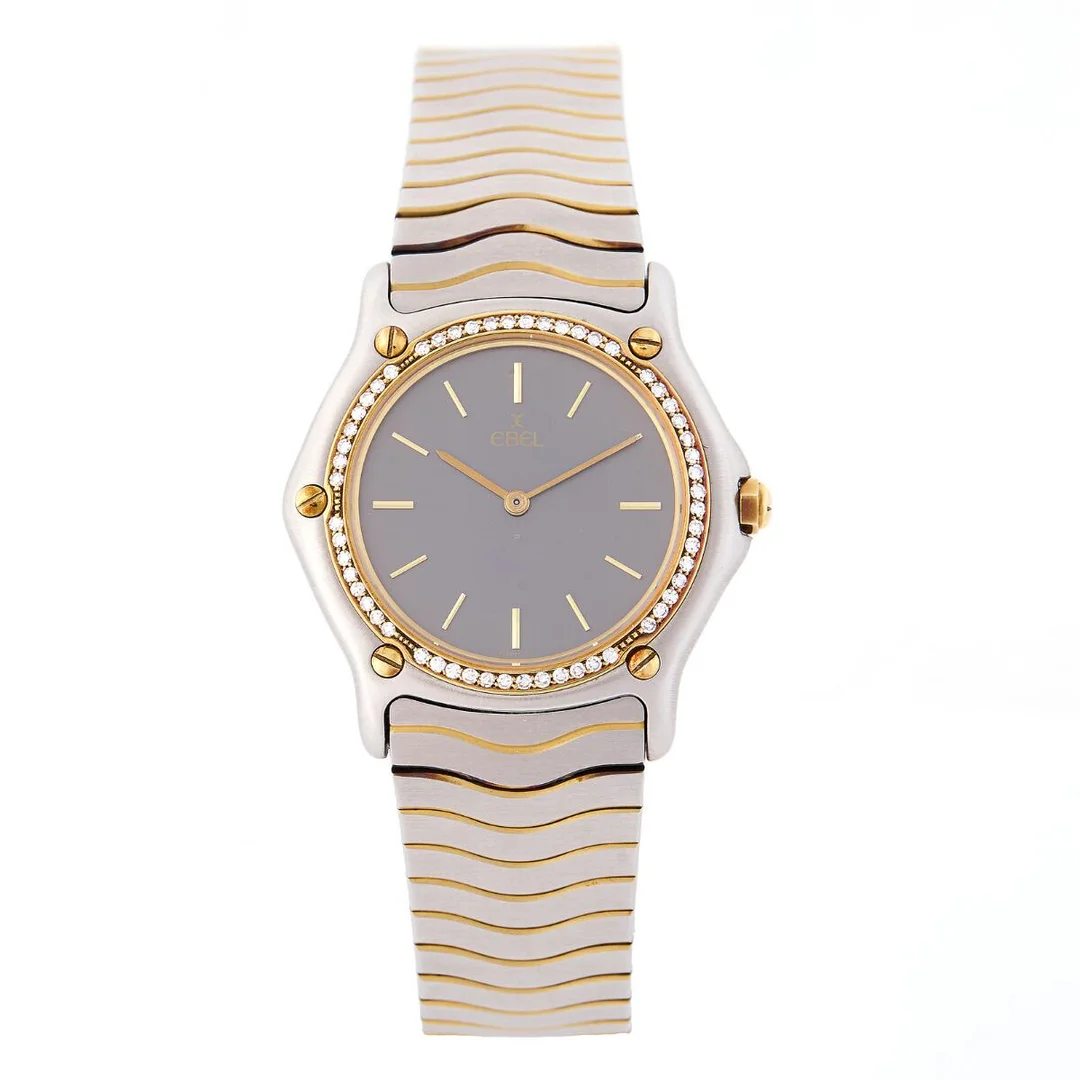 Wristwatch of steel and gold with bezel set with 56 diamonds, ref. 977. Quartz movement, cal. ETA. Circumference approximately 18 cm. Ø 32 mm. 1990s. — Clocks & watches/Wristwatches — Bruun Rasmussen