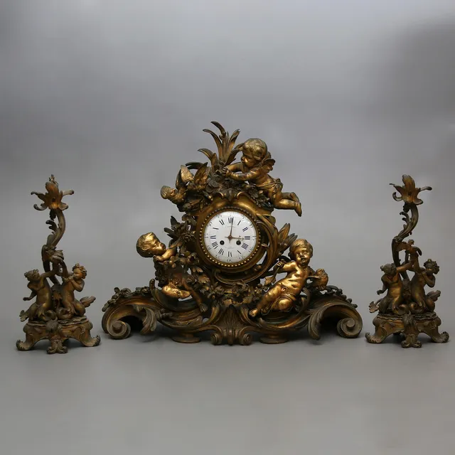 FERDINAND BARBEDIENNE. Napoleon III gilt bronze clock and pair of candelabra garnish, third quarter of the 19th Century.