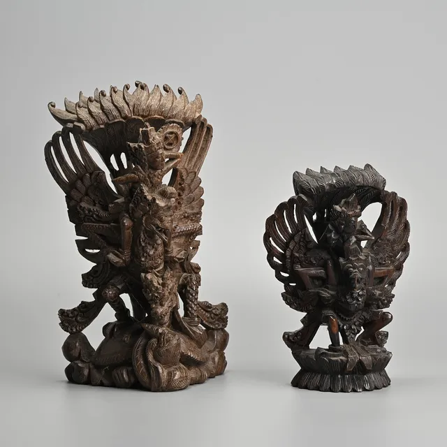 TWO BALINESE BUDDIHST WOOD CARVINGS OF VISHNU RIDING GARUDA, 20TH CENTURY.
