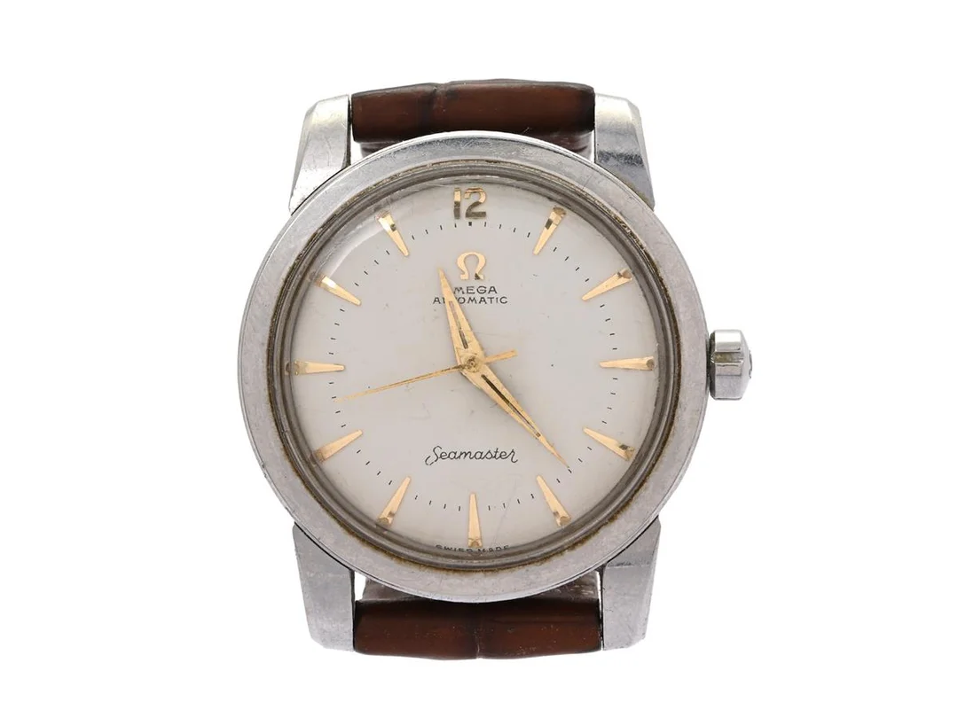OMEGA, Seamaster, Cal 354, Serie nr. 13870512, Ref nr. CK 2577, Boett nr. C 2577-9 SC, herrur, 34 mm, stål (Staybrite), hammarautomat, plexiglas, skadad urtavla/visare, läderband, ca 1953. — Klockor/Omega — Kaplans