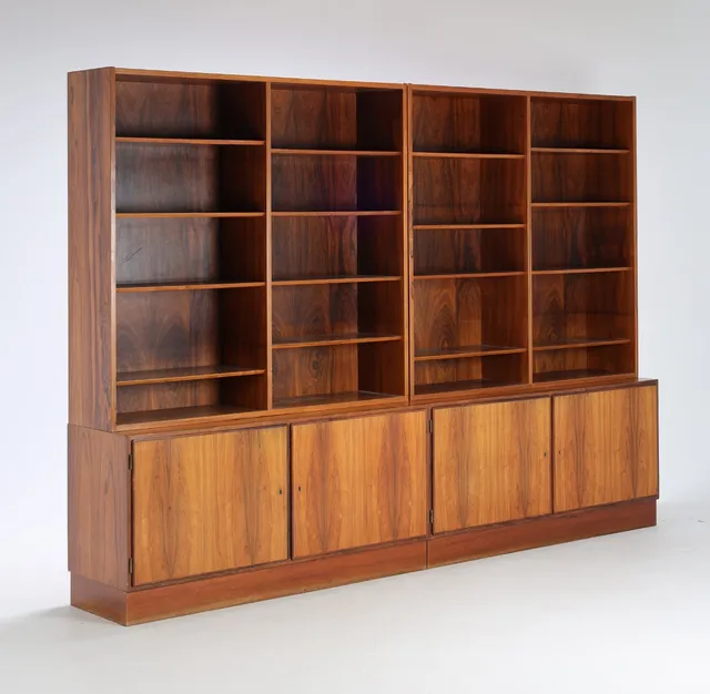 Danish furniture manufacturer: Shelving wall of rosewood in four sections with open shelves and base cabinets