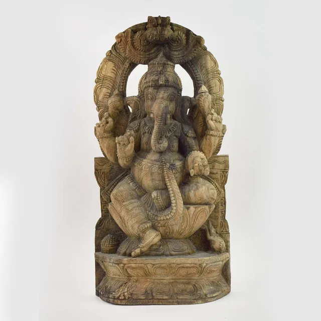 A CARVED WOOD FIGURE OF GANESH.