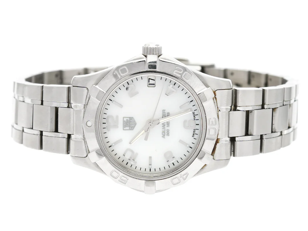 TAG HEUER, Aquaracer (300 Meters), Serie nr. EWE5967, Ref nr. WAF1311.BA0817, Boett nr. WAF1311, damur, 32 mm, stål, quartz, safirglas, datum, pärlemorurtavla, originallänk, viklås, Ref nr. FAA035-G-T2, cert, januari 2010, box. — Klockor/Tag Heuer — Kaplans