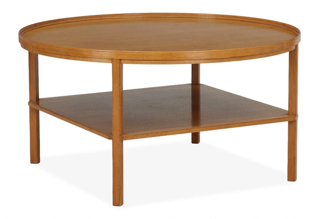 A mahogany coffee table with raised edge and underlying shelf. Model 6687. Designed 1929. Made and marked by Rud. Rasmussen Snedkerier. H. 52. Diam. 100 cm. — Modern Furniture — Bruun Rasmussen