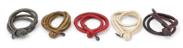 A collection of leather bracelets in various colours with logo charms. L. 36–38 cm. (5)