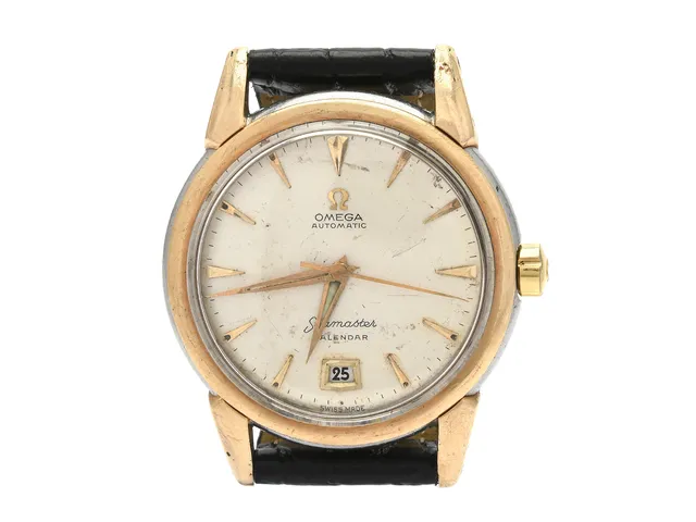 OMEGA, Seamaster, Calendar, Cal 353, Serie nr. 13111140, Ref nr. KO 2627, Boett nr. 2627-14 SC, herrur, 35 mm, guld på stål (Staybrite), hammarautomat, plexiglas, datum, skadad urtavla, defekt, skadad boett, läderband, ca 1952.