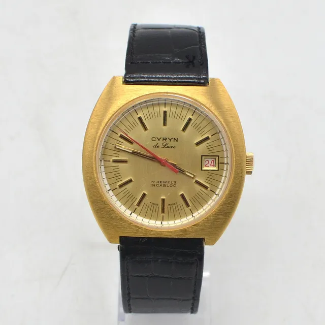 CYRYN DE LUXE, HERRENARMBANDUHR, 17 JEWELS INCABLOC, VERGOLDETES EDELSTAHLGEHÄUSE, HANDAUFZUG, DAYDATE-ANZEIGE, UM 1960ER JAHRE.
