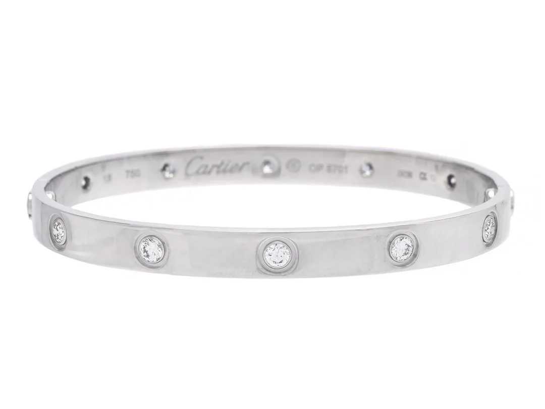 CARTIER, armband, Love bracelet, 18K vitguld, 10 briljantslipade diamanter, ref. nr OP5701, stl 18, vikt 31 g, skruvmejsel, originaletui — Smycken/Armband — Kaplans