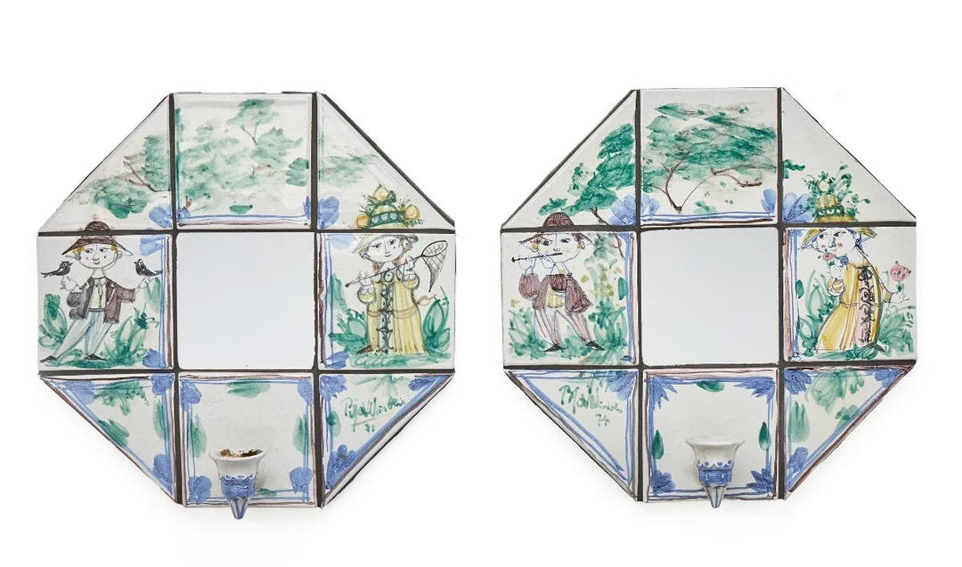 A pair of wall candle sconces with earthenware tiles decorated with a blue-glazed pattern on a light grey base. Fitted with mirrors and mounted on grey-painted chipboard. Signed Bjørn Wiinblad, 71. W./H. 38 cm. D. 12 cm. (2) — Modern Decorative Art — Bruun Rasmussen