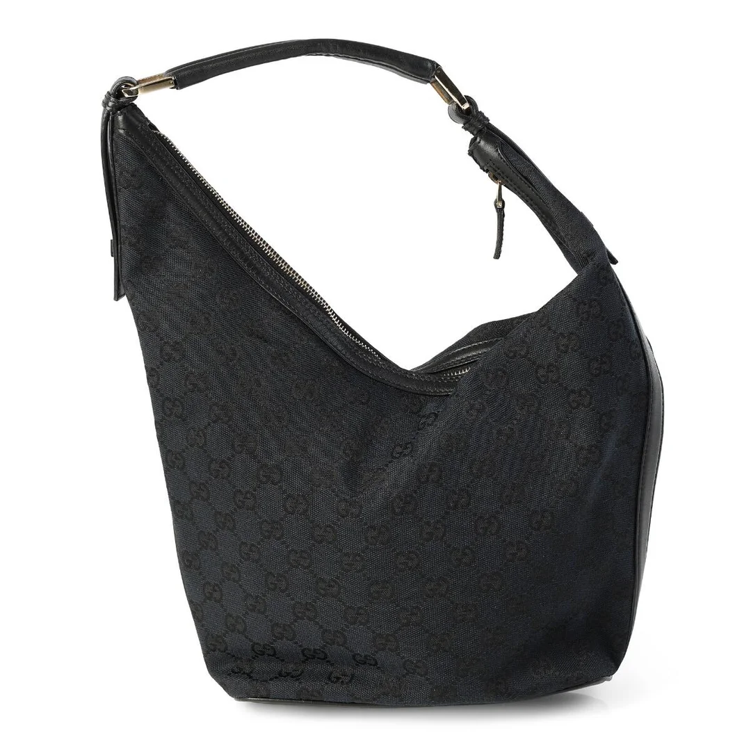 A bag of black monogram canvas with black leather trim, gold tone hardware, a zip compartment with an internal zip pocket and black lining. H. 21 x W. 28 x D. 10 cm. — Designer Handbags & Fashion/Designer Handbags — Bruun Rasmussen