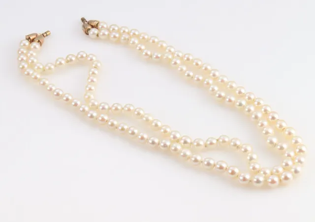 Per Borup. Double-strand saltwater cultured pearl necklace mounted with satin-finished 14 kt. gold end pieces