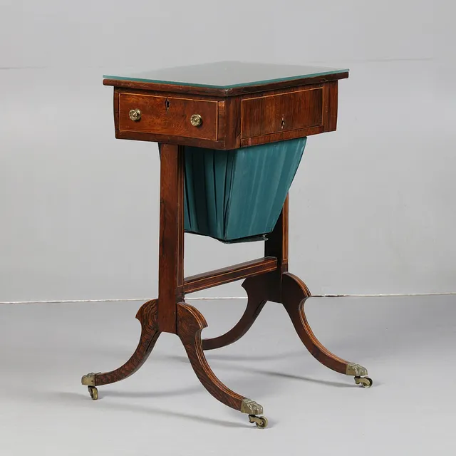 A REGENCY ROSEWOOD SEWING TABLE.