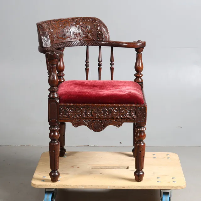 A VICTORIAN OAK CORNER CHAIR DATED 1889.