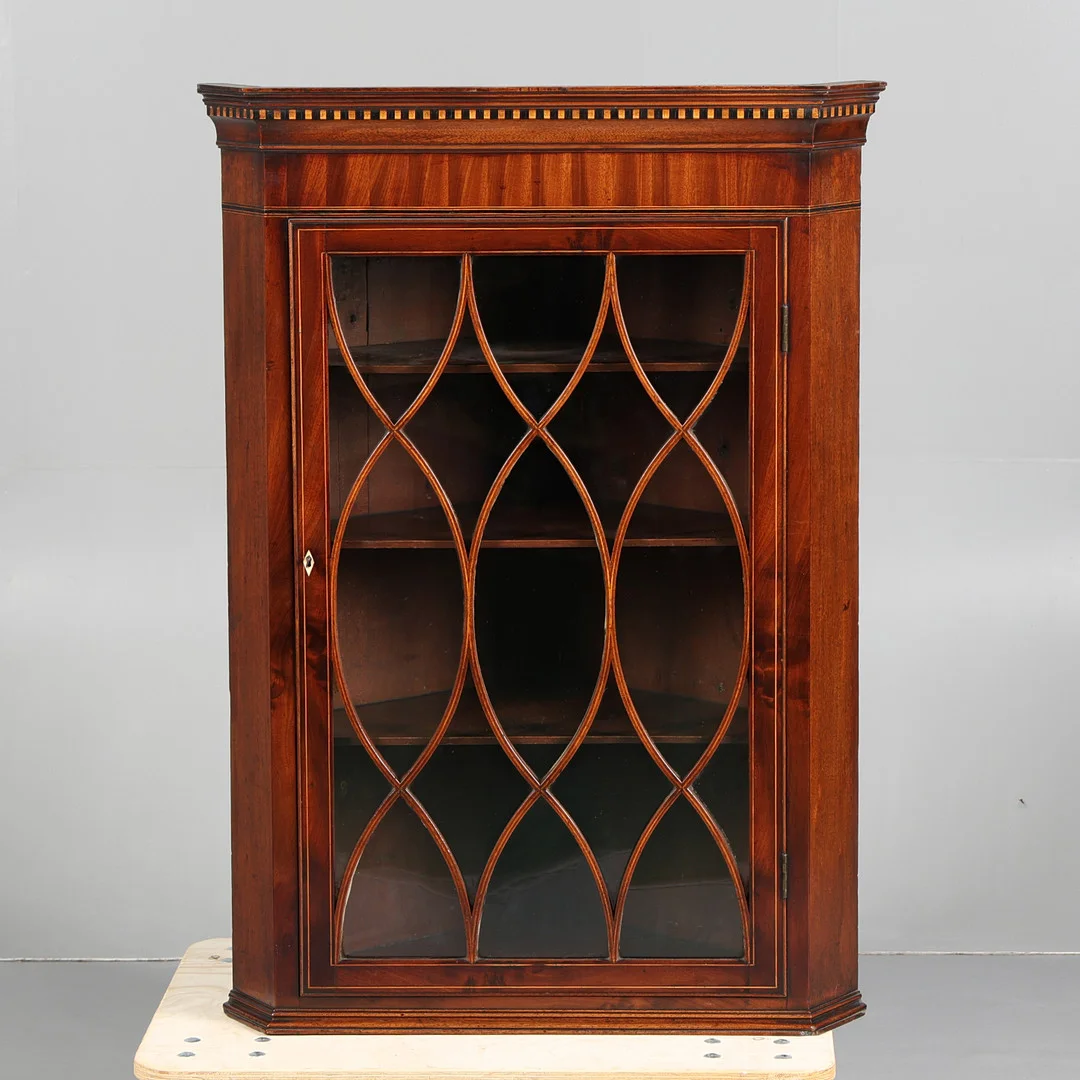 A GEORGE III MAHOGANY AND BOXWOOD HANGING CORNER CUPBOARD. — Cupboards, Cabinets & Shelves — Bishop & Miller