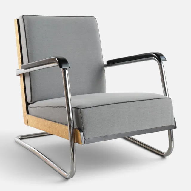 PAULI BLOMSTEDT (1900-1935). Frisvinger lænestol med forkromet stel, sider af Masur birk, betrukket med gråt stof. Udført hos Adelta, model '8160', anden halvdel af det 20. århundrede.