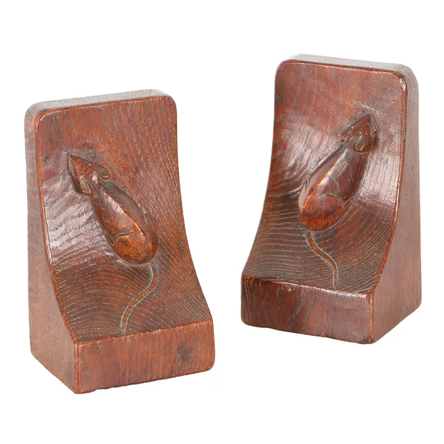 ROBERT MOUSEMAN THOMPSON (1876-1955): A PAIR OF ENGLISH OAK BOOK ENDS.