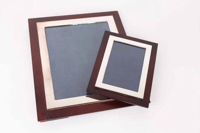 Two modern English wooden photo frames with sterling silver mounting. (2)