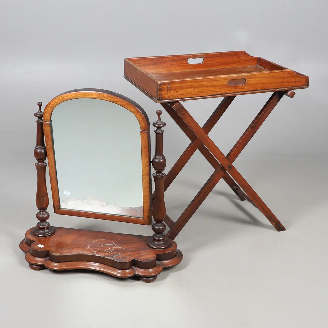A MAHOGANY BUTLERS TRAY ON FOLDING STAND AND A MAHOGANY SWING TOILET MIRROR. — Tables — Lawrences Auctioneers