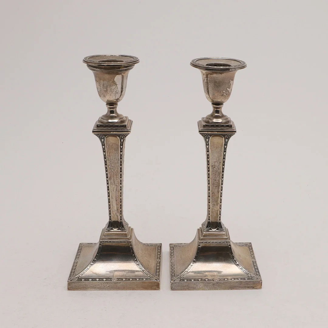 A PAIR OF EDWARDIAN CANDLESTICKS. — Silver — Lawrences Auctioneers