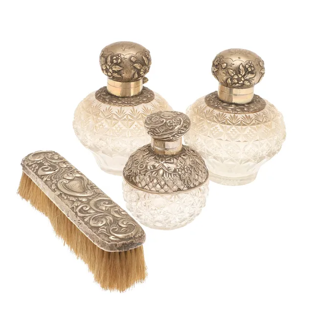A PAIR OF VICTORIAN SILVER MOUNTED GLASS SCENT BOTTLES.
