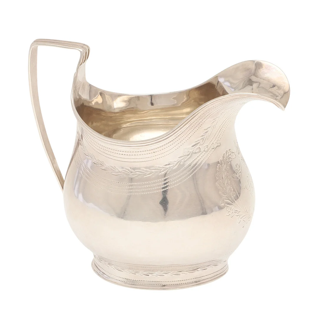 A GEORGE III SILVER HELMET SHAPED CREAM JUG. — Silver — Lawrences Auctioneers