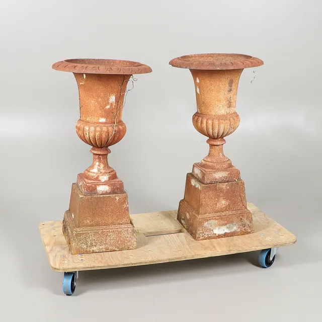 A PAIR OF CAST IRON CAMPANA URNS.