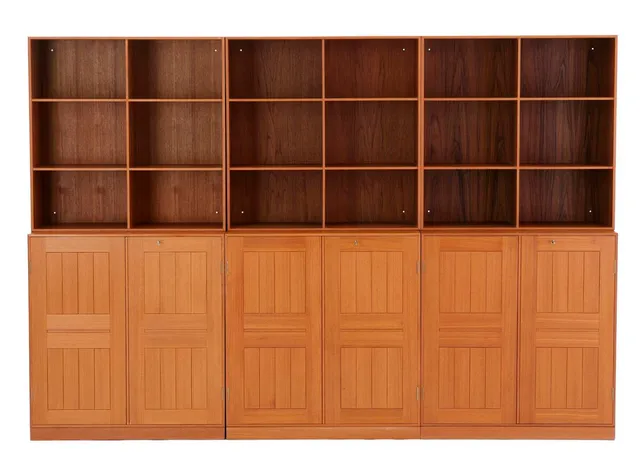 Solid teak wall unit, consisting of three cabinets with plinths and three bookcases. One cabinet with six small drawers, one with narrow deep drawer. Made and marked 2000s by Rud. Rasmussen Cabinetmaker's. H./W. 76 cm. D. 27,5/36 cm. Plinth H. 5 cm. (9)