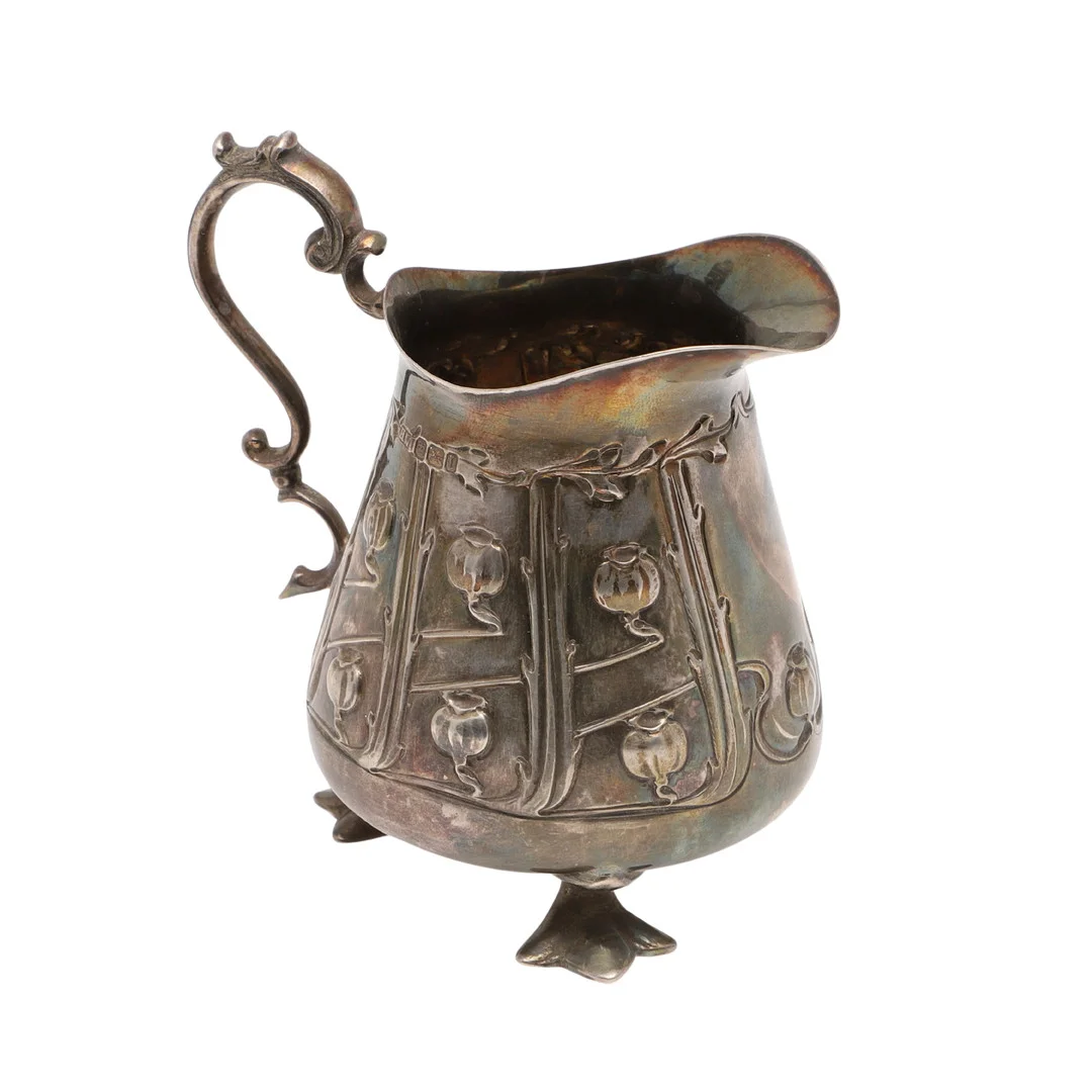 AN EDWARDIAN ART-NOUVEAU SILVER CREAM JUG. — Silver — Lawrences Auctioneers