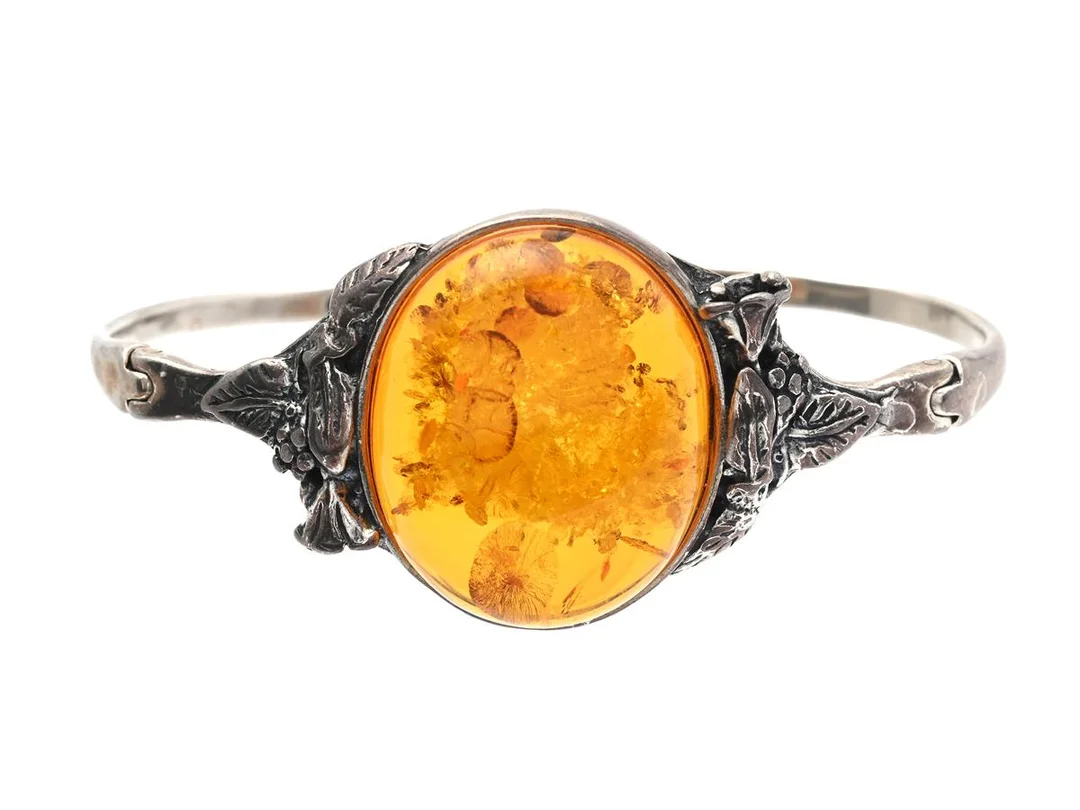ARMRING, stel, öppningsbar, sterlingsilver, cabuchonslipad bärnsten ca 27 x 23 mm, innermått ca 62 x 41 mm, vikt 22,7 g, säkerhetsögla. — Smycken/Armring — Kaplans