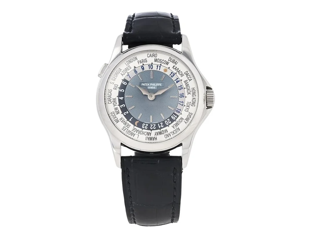 PATEK PHILIPPE, World Time, Complications, "Geneva Seal", Cal 240 HU, Serie nr. 3211392, Ref nr. 5110P-001, Boett nr. 4210489, herrur, 38,5 mm, platina, automatisk (microrotor), safirglas, 24-timmarsvisning, glasbaksida, läderband, viklås i platina, cert, juli 2003, box (skadad), ytterkartong. — Klockor/Patek Philippe — Kaplans
