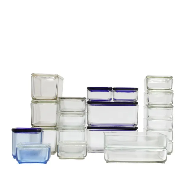 A collection of pressed glass containers with lid. Designed 1938. Manufactured and partially marked by Vereinigte Lausitzer Glaswerke, Tyskland andHolmegaard. (21)
