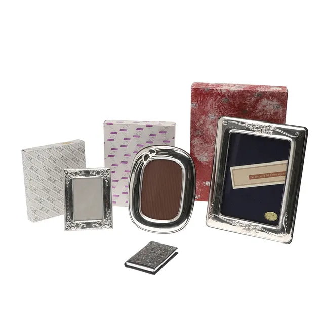 THREE BOXED SILVER PHOTO FRAMES.