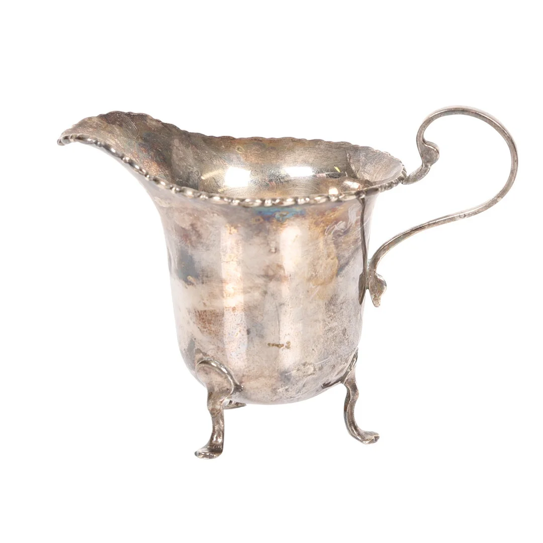 A GEORGE V SILVER CREAM JUG. — Silver — Bishop & Miller